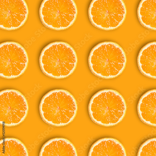Slices of fresh ripe tangerines on orange background, flat lay