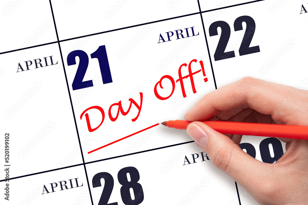 Hand writing text DAY OFF and drawing a line on calendar date 21 April. Vacation planning concept. Hand writing text DAY OFF and drawing a line on calendar date 21 April. Vacation planning concept.