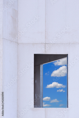    Blurred blue sky view inside 2 window frames on brick smartboard wall pattern of vintage building structure under construction in vertical frame