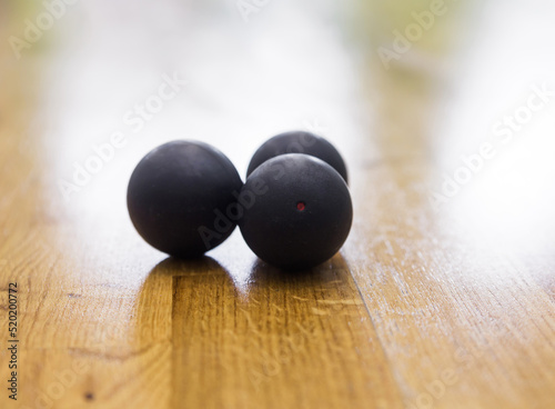 Black squash balls in squash court