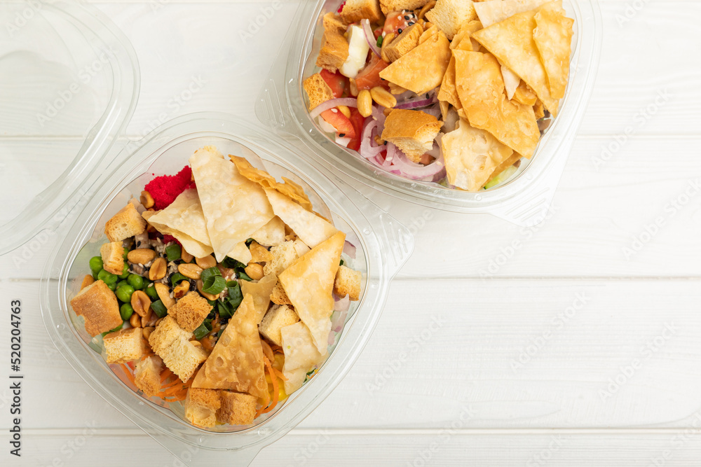 Poke from salmon, funchose, vegetables and pita crispy on a white wooden background.Healthy healthy food.Hawaiian food. View from above. Place to copy. Poke from salmon, funchose, vegetables and pita crispy on a white wooden background.Healthy healthy food.Hawaiian food. View from above. Place to copy.