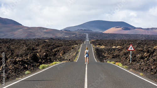 Traveler on the LZ-67 road leading to the Timanfaya National Park, in Lanzarote, Canary Islands, Spain