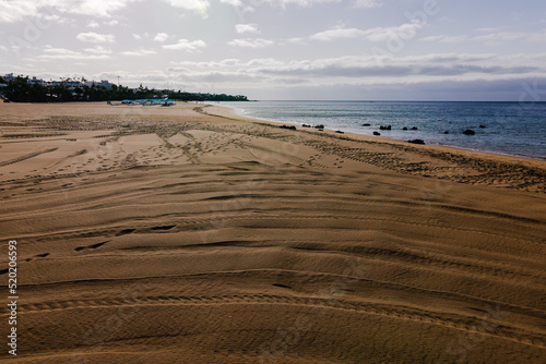 The large beach of Playa Grande in the city of Puerto del Carmen on the island of Lanzarote Canary Islands, Spain photo