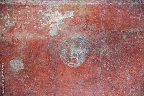 Photography POMPEII, ITALY - MAY 04, 2022 - Scenic mask in a fresco of an ancient Roman vill