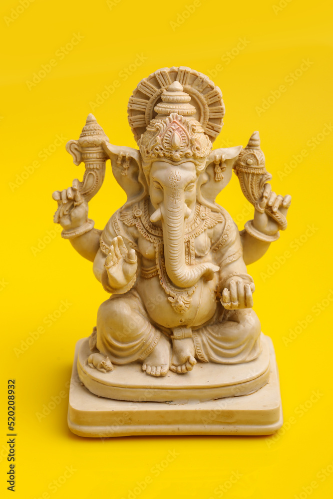 Lord Ganesha Sculpture on yellow background. Lord Ganesha Sculpture on yellow background.
