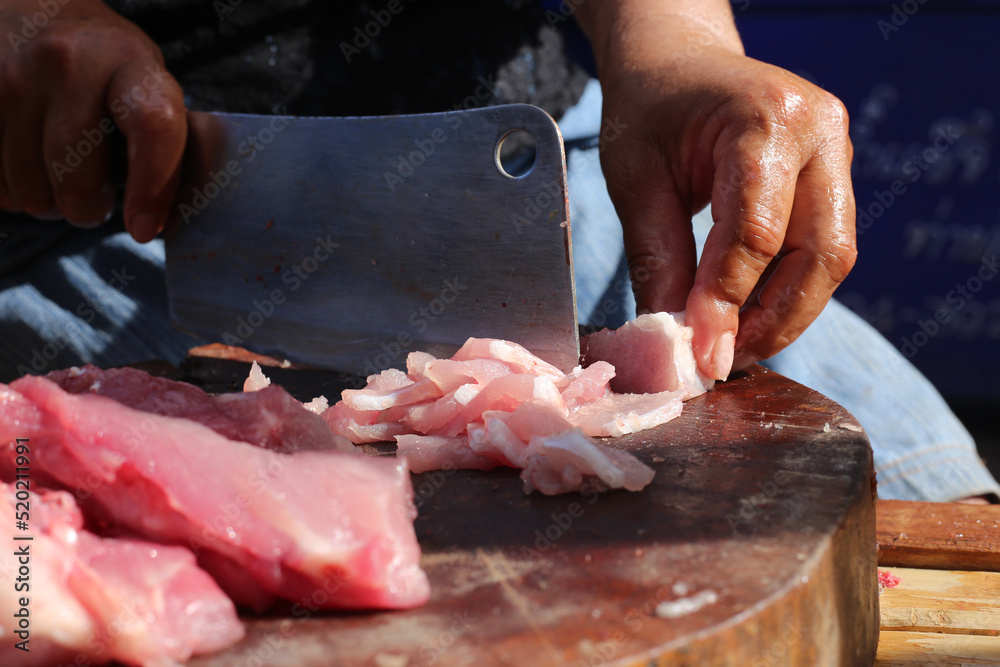 Raw pork chop on cutting board, pig shoulder butt meat cut out,Market of raw production. Raw pork chop on cutting board, pig shoulder butt meat cut out,Market of raw production.