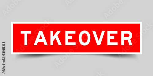 Red color square shape sticker label with word takeover on gray background