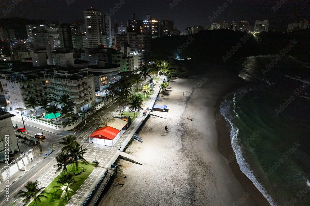Obraz premium Guarujá city at night. View of Praia do Tombo and Praia das Asturias. Beaches on the coast of Santos.