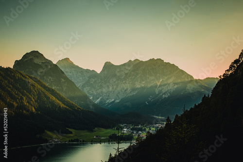 Achensee, lake in sunset light in Tirol Alps. Beautiful landscape with green trees, meadow, rocks and blue sky with clouds in the mountains. Summer landscape scene from nature, Tirol Alps, Austria