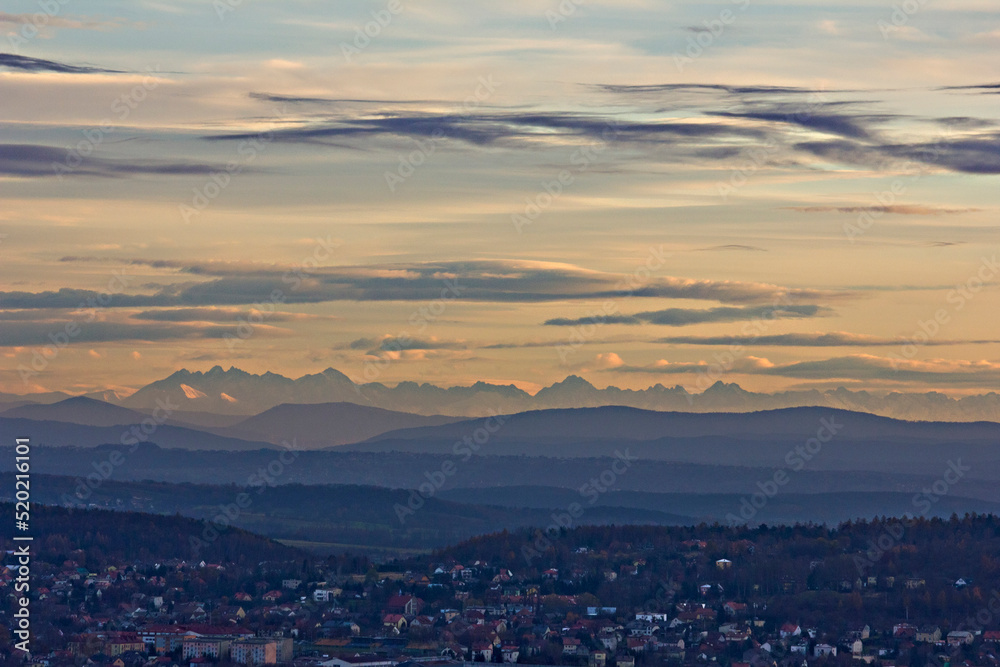 Obraz premium beautiful landscape view from a height to the village, mountains and picturesque cloudy sky