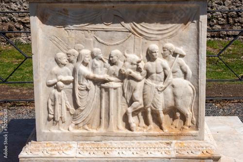 POMPEII, ITALY - MAY 04, 2022 - fresco on an ancient marble altar in the Roman city of Pompeii, Italy