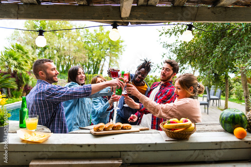Canvas Print Happy multiethnic young people toasting at kiosk bar of pool – multiracial group