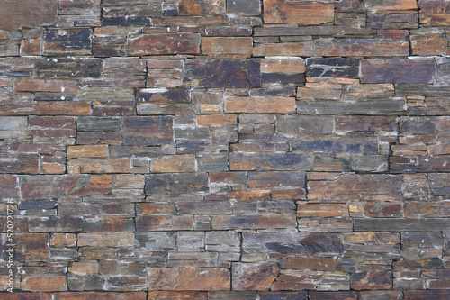 Textura de superficial de um muro construido em pedaços de pedras de xisto photo