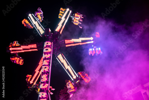 Fun Fair rides at night with colorful lights