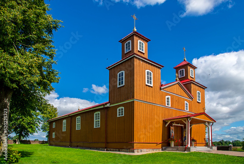 Fototapeta Naklejka Na Ścianę i Meble -  Built in the years 1924-26, a sacred complex consisting of a belfry and a wooden Catholic church dedicated to Our Lady of Częstochowa in the town of Žilina in Masuria in Poland.