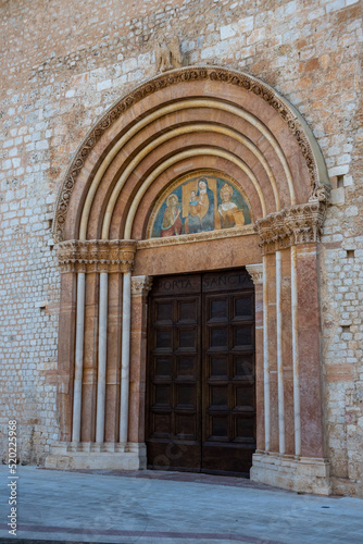 Ornate side door of the rebuilt Romanesque basilica di Santa Maria di Collemaggio in L'Aquila, Italy © imagoDens