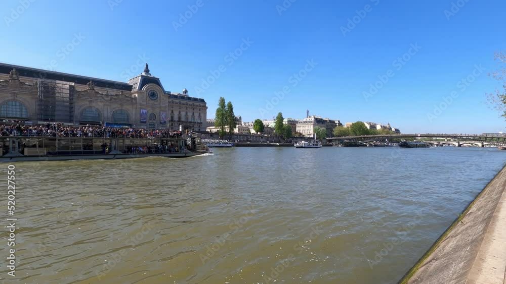 A tourist boat crossing the Seine river in Paris in front of the Orsay Museum. France, Europe. A tourist boat crossing the Seine river in Paris in front of the Orsay Museum. France, Europe.
