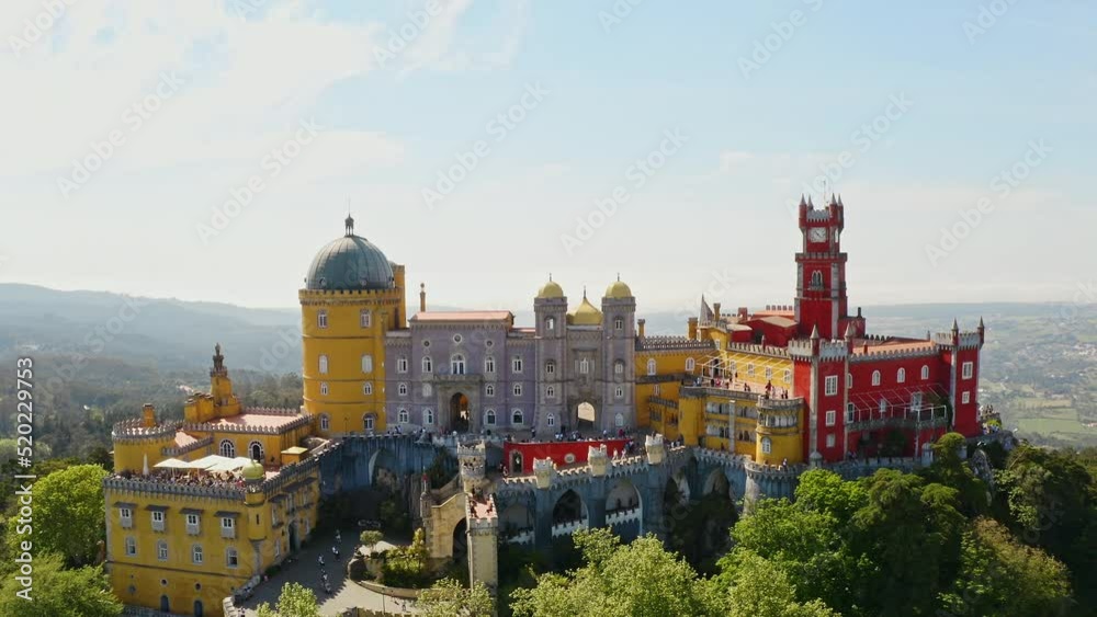 High aerial view Pena palace portuguese heritage of unesco stronghold historic european residence catholic fortress with yellow red decorative facade mansion on summit rocky hilltop in Sintra Portugal