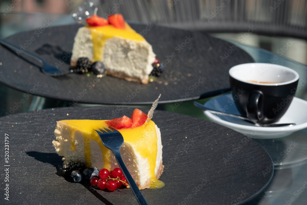 Cheesecakes with berries in a street restaurant