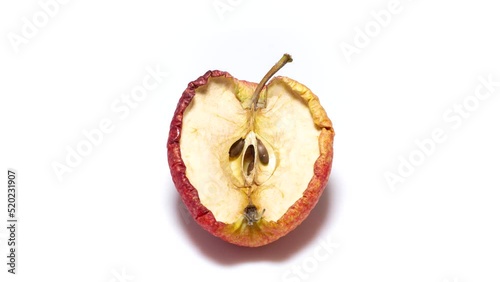 Red apple becomes dry and wrinkled. Half cutted fruit dehydrates quickly. Fast timelapse. Concept of aging, time, health, skincare, cosmetic care.