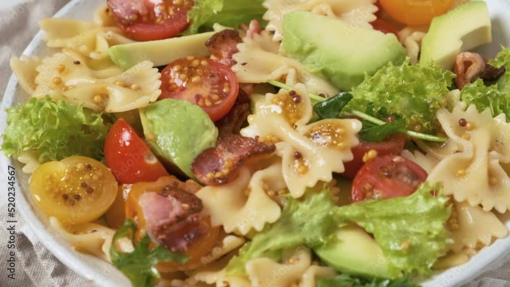 Tasty food. Pasta salad with fresh vegetables, bacon and mustard. Close up. 4k video Tasty food. Pasta salad with fresh vegetables, bacon and mustard. Close up. 4k video