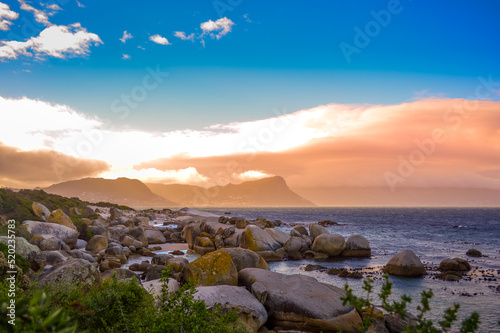 Boulders is a turqoise rocky and sheltered beach in cape town taken as sunset