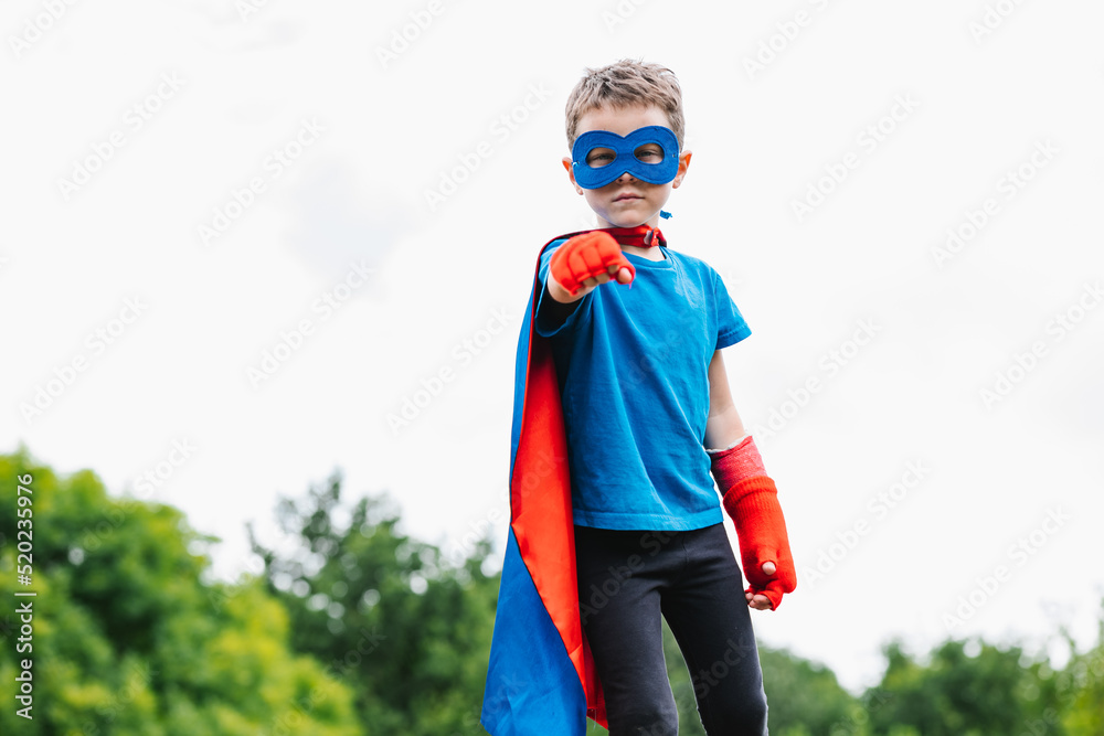 Excited boy in superhero costume in park Excited boy in superhero costume in park