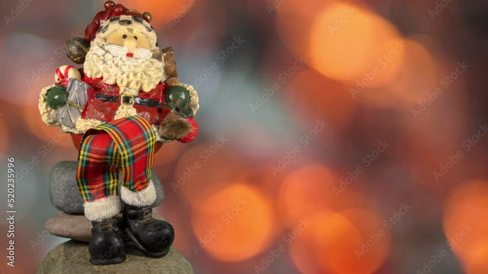 Representation of Santa Claus sitting cross-legged and background with golden blurred lights. Representation of Santa Claus sitting cross-legged and background with golden blurred lights.