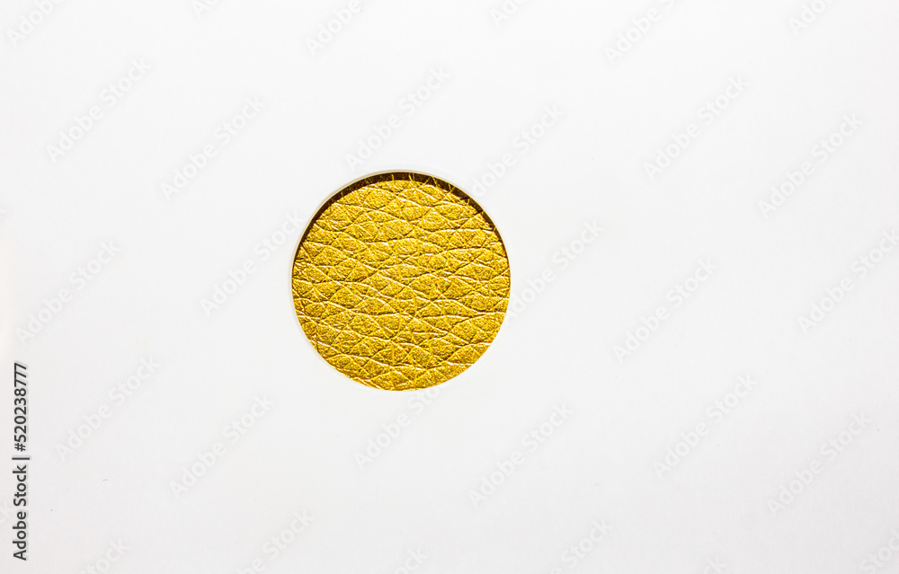 The design is golden. Golden circle. Abstract circle in golden color with leather texture on white background. The design is golden. Golden circle. Abstract circle in golden color with leather texture on white background.