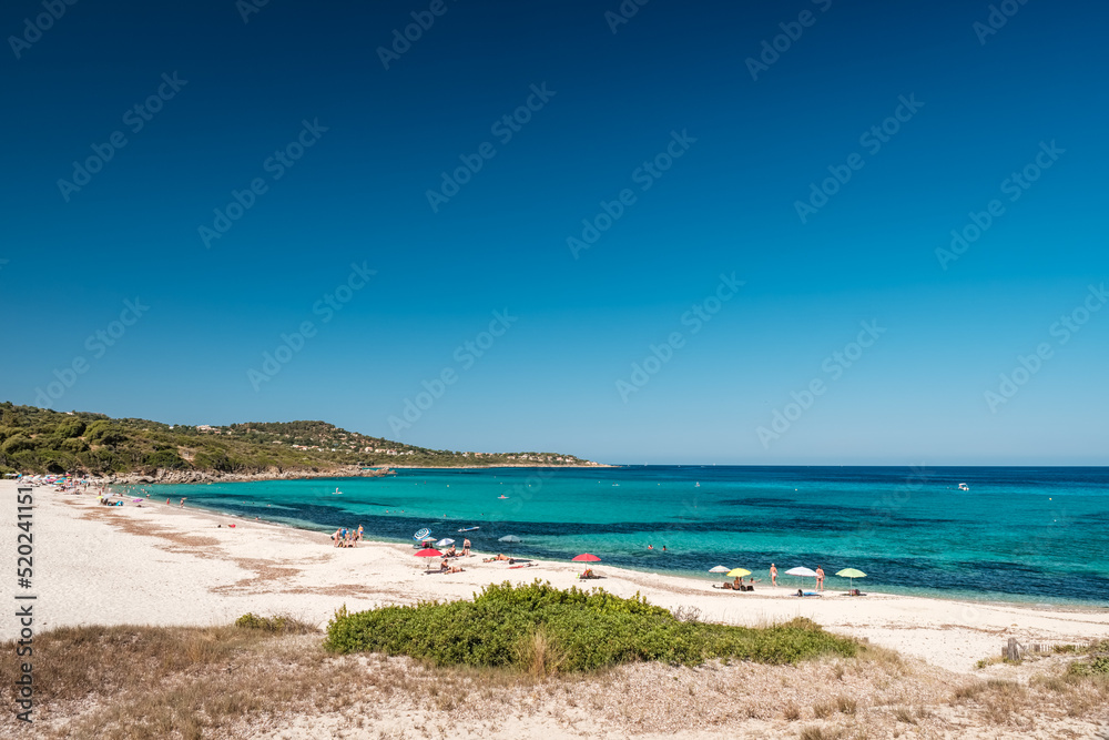 Holidaymakers enjoy the turquoise Mediterranean sea at Bodri beach in the Balagne region of Corsica