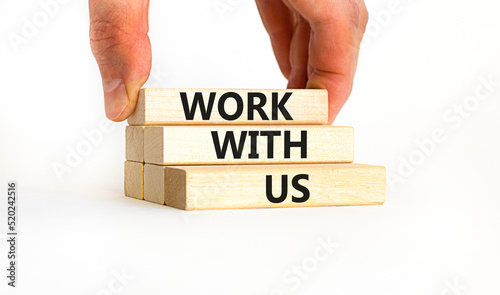 Work with us symbol. Concept words Work with us on wooden blocks on a beautiful white table white background. Businessman hand. Business, motivational and work with us concept. Copy space.