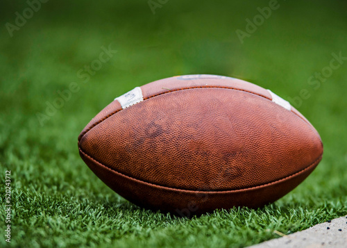 College Leather Football on a grass field