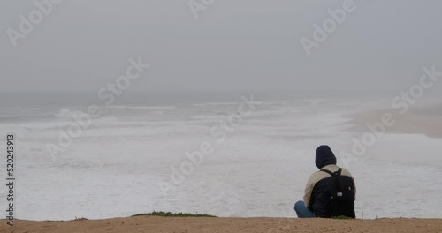 Man sitting on the seashore photo