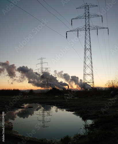 power lines & smokestack at sunset