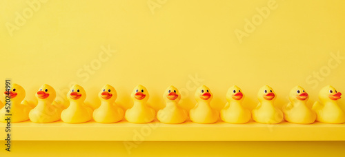 Fotografia Banner yellow rubber duck background yellow ducks in a row