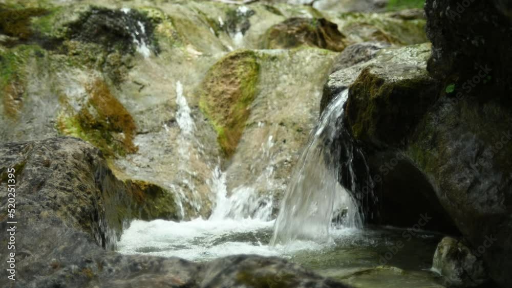Beautiful and wild waterfalls of a small stream in the mountains with clear and clean water Beautiful and wild waterfalls of a small stream in the mountains with clear and clean water