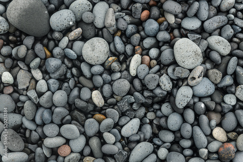 Icelandic beach, sand and stones texture. Gray and black pebble background