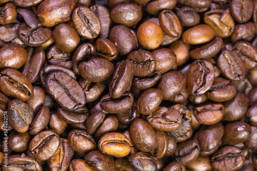 Fototapeta premium Roasted Coffee Beans. Macro Photo Of Coffee Beans, Low Depth Of Focus. Roasted Brown Coffee Beans Pattern, Background, Top View.