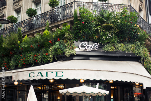 Cafe near the house with a lot of plants