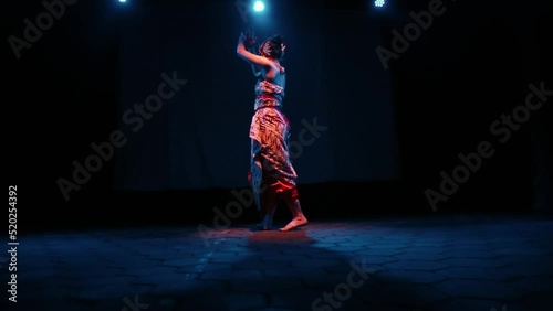 A Java dancer moves her body to the beat while dancing a traditional dance photo