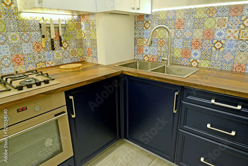 Quadro em tela Gas stove and sink with faucet in the interior of a modern kitchen