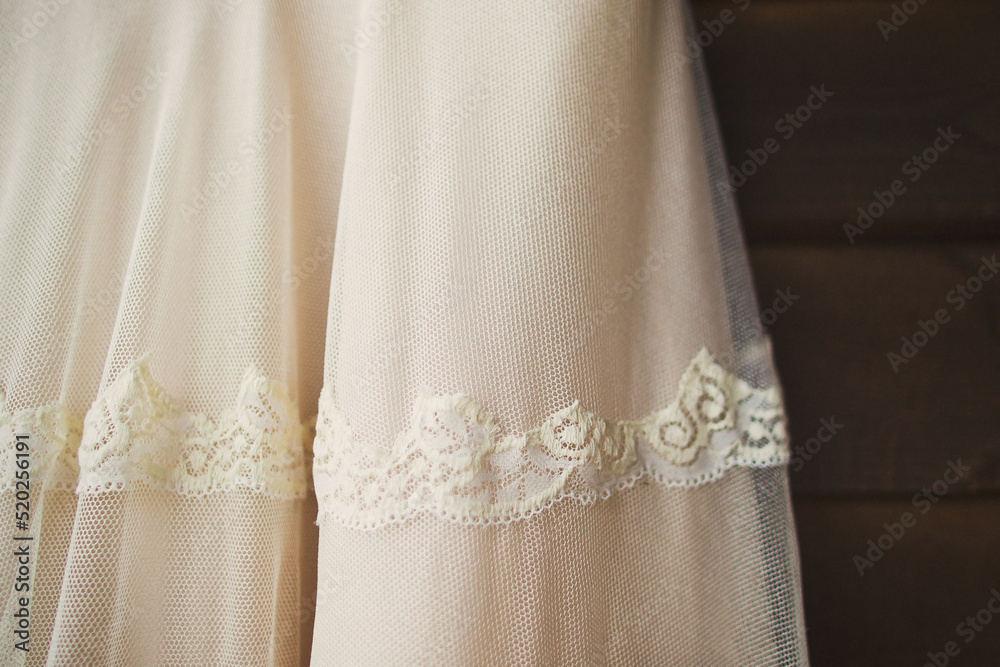 Beige wedding dress with lace. Details closeup Beige wedding dress with lace. Details closeup
