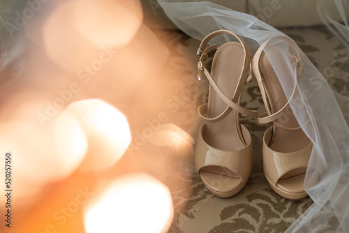 Wedding shoes and veil on wooden floor