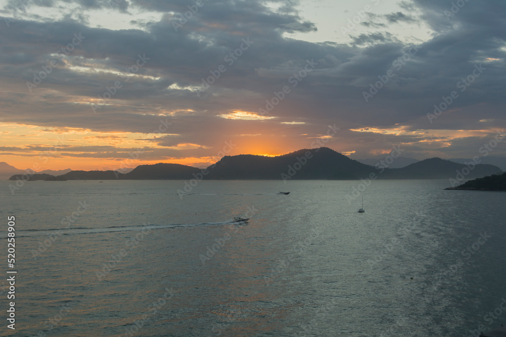 Sunset over the sea at Angra dos Reis town, State of Rio de Janeiro, Brazil. Taken with Nikon D7100 18-200 lens, at 20mm, 1/250 f 7.1 ISO 200. Date: Dec 30, 2020 Sunset over the sea at Angra dos Reis town, State of Rio de Janeiro, Brazil. Taken with Nikon D7100 18-200 lens, at 20mm, 1/250 f 7.1 ISO 200. Date: Dec 30, 2020