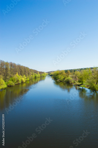 Beautiful landscape with a pond. Large stones in the river. © Yevhenii