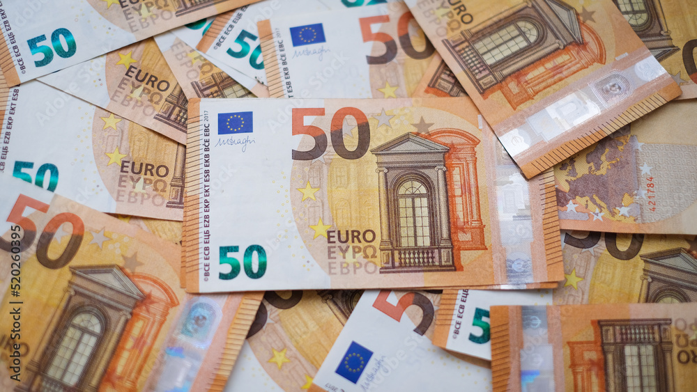 The background consists of many euro banknotes of different denominations. Finance and business concept The background consists of many euro banknotes of different denominations. Finance and business concept