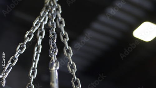 punching bag hanging in the gym on the chains. Punching bag chain © Media Whale Stock