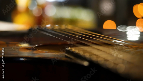 Acoustic guitar bridge and strings close up. Close-up of guitar strings. Elegant guitar photo