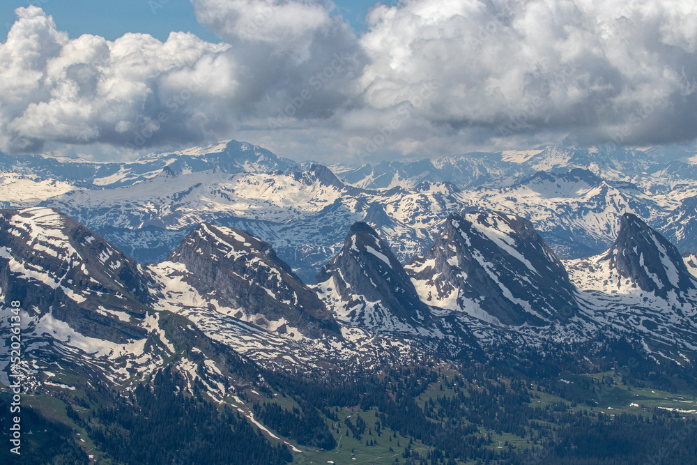 Alpine peaks in the summer under the dramatic clouds
