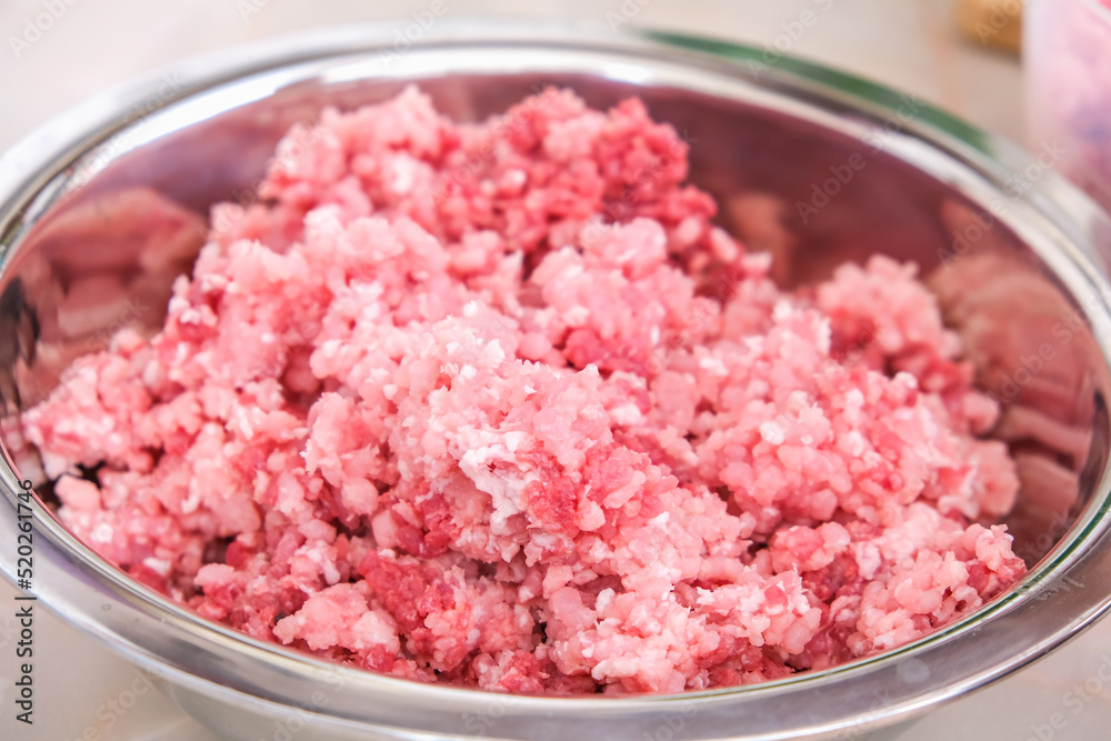 A man mixes minced meat in a bowl with his hands. Preparation of minced beef and pork for cutlets, meatballs, chops. A man mixes minced meat in a bowl with his hands. Preparation of minced beef and pork for cutlets, meatballs, chops.